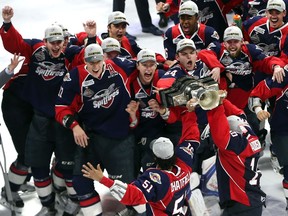 Windsor Spitfires players go crazy as they are presented the Memorial Cup after the team defeated the Erie Otters to win the Memorial Cup final at the WFCU Centre in Windsor on May 28, 2017.