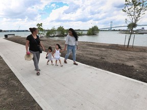 Tammy Elliott walks with Tanisha Szeto, right, and Szeto's two children Mulan, 2, and Meilin, 4, at the new Mill Street Parkette along the riverfront in the city's west end on May 29, 2017. Elliott and Szeto of the Sandwich Teen Action Group where among the volunteers helping shape the park and plant a wildflower garden on the weekend. Other volunteers came ftom the Detroit River Canadian Cleanup, Essex Region Conservation Authority, Union Gas, the Alpha Kappa Alpha sorority and the Windsor Port Authority.