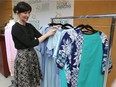 Elaine Chatwood, coordinator of the St. Clair College Fashion Design program, on May 30, 2107, shows some of the designer hospital gowns created by St. Clair students.
