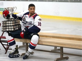 The Windsor Spitfires Jeremiah Addison sits with the Memorial Cup as the team prepares for the official team portrait at the WFCU Centre in Windsor, Ontario on May 30, 2017.