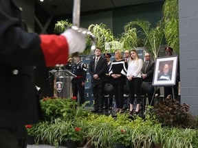 Mitchell, Shelley and Nicole Atkinson (left to right) take part in a tunnel dedication in honour of their father and husband Windsor Police officer Const. John Atkinson at St. Clair College on May 5, 2017 in Windsor.