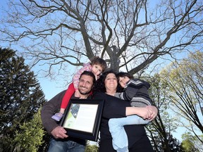 Andre Abouasli, his daughter, Christina, 3, wife, Hoda and son Nicolas, 5, stand under the giant sycamore tree on their South Windsor property May 8, 2017. The tree has received heritage designation.