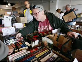 Stephen King fan Karen Whyte selects a few novels during the Raise-A-Reader book sale at LaSalle's Windsor Crossing on May 6, 2017.