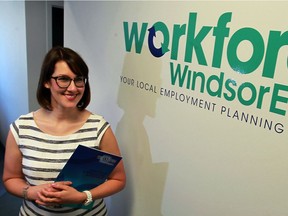 Heather Gregg, manager of employer engagement, stands next to the new Workforce WindsorEssex logo on June 10, 2016.