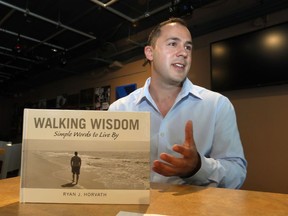 Author Ryan Horvath poses his inspirational book, Walking Wisdom, on June 12, 2017.