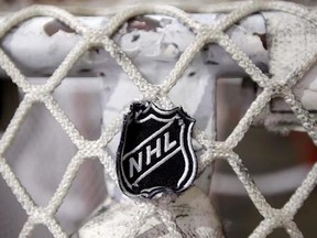 In this file photo taken Sept. 17, 2012, the NHL logo is seen on a goal at a Nashville Predators practice rink in Nashville, Tenn. The salary cap is going up after all in the National Hockey League. The NHL and NHLPA announced an upper limit of US$75 million for the 2017-18 season ??? up from $73 million last season. THE CANADIAN PRESS/AP/Mark Humphrey