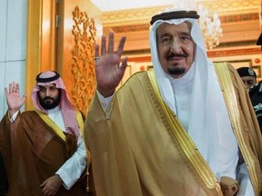FILE -- In this April 5, 2017 file photo, released by the Saudi Press Agency, SPA, Saudi King Salman, right, and Defense Minister and Deputy Crown Prince Mohammed bin Salman wave as they leave the hall after talks with the British prime minister, in Riyadh, Saudi Arabia. Saudi King Salman has put his 31-year-old son, Mohammed bin Salman, next in line to take over the oil-rich kingdom with a royal decree Wednesday. (Saudi Press Agency via AP, File)