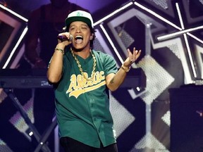 FILE - In this Dec. 2, 2016, file photo, Bruno Mars performs at the 2016 Jingle Ball at Staples Center in Los Angeles. The ‚ÄúB‚Äù in BET Awards could stand for Beyonce, or Bruno Mars. Both pop stars are the top nominees at Sunday‚Äôs show, June 25, 2017, where they will compete in four of the same categories, including video of the year. Mars, who will open the show at the Microsoft Theater in Los Angeles, is nominated for five awards. (Photo by Chris Pizzello/Invision/AP, File)