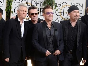 FILE - This Jan. 12, 2014 file photo shows members of the Irish rock band U2, from left, Adam Clayton, Larry Mullen, Jr., Bono, and The Edge at the 71st annual Golden Globe Awards at the Beverly Hilton Hotel in Beverly Hills, Calif. Clayton thanked his bandmates on Monday, June 26, 2017, for their support during his treatment and recovery from alcohol abuse years ago, before joining them for a rollicking rendition of a few hits. Clayton received an award Monday at a Manhattan theater from MusiCa