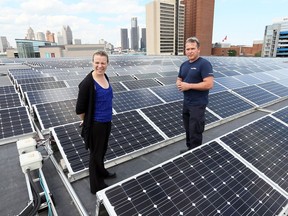 Karina Richters and Daryl Brisbois stand among hundreds of solar panels on top of the Windsor International Aquatic and Training Centre and Adventure Bay Family Water Park June 21, 2017.