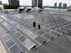 Karina Richters, front, and Daryl Brisbois with hundreds of solar panels on top of City of Windsor owned Windsor Aquatic and Training Centre and Adventure Bay Family Water Park June 21, 2017.  The panels collect 350 kilowatts.