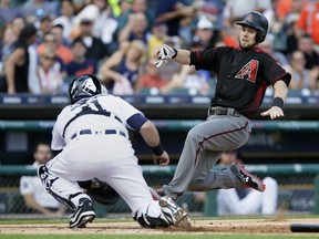 Chris Owings #16 of the Arizona Diamondbacks slides into the tag from catcher Alex Avila #31 of the Detroit Tigers during the first inning at Comerica Park on June 14, 2017 in Detroit, Michigan. Owing attempted to score from from second base on a single by Brandon Drury.