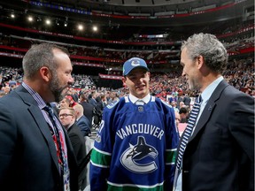 CHICAGO, IL - JUNE 24:  Michael DiPietro meets with executives after being selected 64th overall by the Vancouver Canucks during the 2017 NHL Draft at the United Center on June 24, 2017 in Chicago, Illinois.