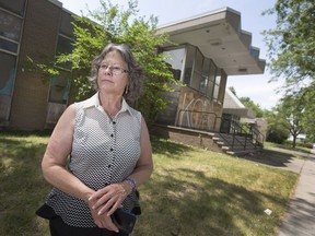 Mary Jane Renaud stands outside the former city-owned social services building on Louis Avenue, June 29, 2017. It and other adjacent former public buildings sit vacant and vandalized and are now used for drugs and prostitution.