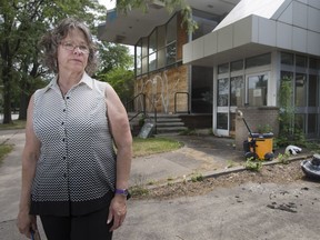 Mary Jane Renaud, a nearby resident, stands outside the former city-owned social services building on Louis Avenue on Thursday, June 29, 2017. The building is now vacant and is used for drugs and prostitution.  Renaud has organized a petition that's been submitted to City Hall.