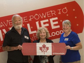 Those being recognized for their 150 donations, from left, Richard McCaffrey, Katherine Ducharme, and Margaret Adams Quick, pose for a photo in a nod to Canada's 150 birthday, during Canadian Blood Services' Honouring Our Lifeblood at the Fogolar Furlan, Monday, June 12, 2017.