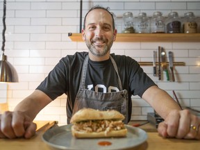 Bread Meats Bread co-owner, David Prantera, is pictured with the Italian Job, a porchetta sandwich on a baguette, on June 20, 2017. Prantera is one of the entrepreneurs helping revive Chatham Street.