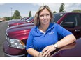 Randi Soulliere, a sales representative at Motor City Chrysler, is pictured May 2, 2017, next to a row of RAM 1500 trucks, which helped set the company's best-ever monthly sales record.