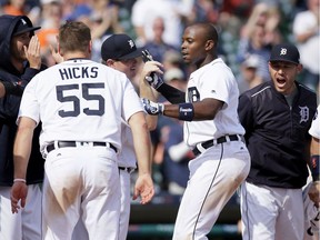 Justin Upton #8 of the Detroit Tigers celebrates with teammates John Hicks #55, pitcher Justin Wilson #38 and Ian Kinsler #3 after hitting a three-run home run in the bottom of the ninth inning to defeat the Chicago White Sox 7-4 at Comerica Park on June 4, 2017.