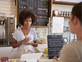 A waitress writes a customer's order.