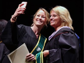 Samantha Guilbault, left, a graduate of the dental hygiene program stops to take a selfie with course co-ordinator Leslie Rebner after receiving her diploma during the St. Clair College's 50th annual convocation ceremonies on June 15, 2017.