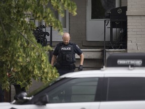 An officer with the Windsor police forensics unit exits a home at 924 Windsor Ave. on June 18, 2017. Police arrested a male Saturday night after reports of shots fired and following a standoff.