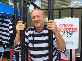 Larry Horwitz, chairman of the Downtown Windsor Business Improvement Association, stands in a makeshift cell on Ouellette Avenue as part of a Crime Stoppers Day fundraiser, June 22, 2017.