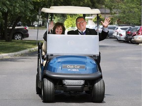 Hospice of Windsor and Essex County executive director Carol Derbyshire and John Swizawski, Grand Knight of St. Peter's Maronite Council 13335, take a spin in a new golf cart after it was donated to Hospice by the Knights of Columbus, St. Peter's Maronite Council and Father Paul Watson Council in Windsor.