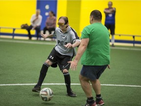 Jason Fathers, 31, left, plays soccer with volunteers at the Italian Canadian Handicapped Association on June 20, 2017.