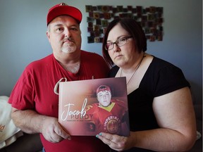 Scott and Debra Purdy hold a photo of their son, Jacob Purdy, 21, who died recently after being involved in a car crash near their Amherstburg home. Always helping others when he was alive, Jacob Purdy's organs were transplanted and saved the lives of five people.