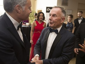 Outgoing WFCU CEO, Marty Komsa, is congratulated by Ari Freed at his retirement celebration at the St. Clair Centre for the Arts, May 2, 2017.