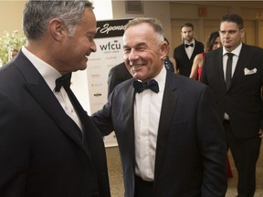 Outgoing WFCU CEO, Marty Komsa, is congratulated by Ari Freed at his retirement celebration at the St. Clair Centre for the Arts, Friday, May 2, 2017.