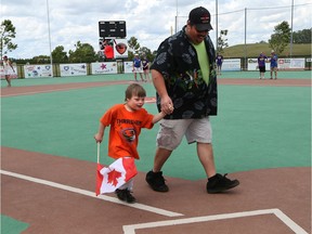 Miracle League of Amherstburg baseball player Edward McAllister, 6, runs towards home plate with his father, Chris, during the final spring baseball game on Saturday June 24, 2017.  Games will resume after Labour Day weekend.