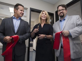 Downtown Mission executive director Ron Dunn, right, is joined by Barry and Stephanie  Zekelman during a ribbon-cutting ceremony for a four-bed dormitory at the Downtown Mission, Tuesday, June 6, 2017.