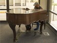 Brad Anderson plays on the grand piano at the Central Public Library on June 21, 2017. The piano was recently brought out of the basement after years sitting in storage.