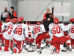 Red Wings coach Jeff Blashill goes over strategy with the team during NHL hockey training camp on Sept. 19, 2015 at Centre Ice in Traverse City, Mich.
