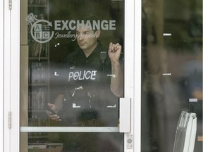Windsor police officers investigate at the scene of an armed robbery at ABC Exchange Jewellery and Cash in the Eastpark Centre plaza on Tecumseh Rd. East, Monday, June 5, 2017.