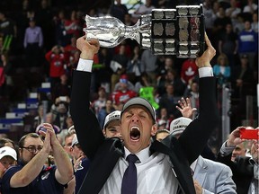 Windsor Spitfires head coach Rocky Thompson lifts the Memorial Cup trophy on May 28, 2017, at the WFCU Centre in Windsor, after defeating the Erie Otters in the championship game..