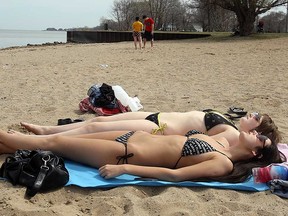 Bikini-clad beach-goers soak up some sun at Windsor's Sandpoint Beach in this 2010 file photo.
