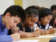 Holy Names Catholic School university scholarship recipients sign letters of intent during an assembly with family, friends, and media, June 20, 2017. From left:  Juan Jaramillo (soccer), Tiarra Davis (basketball) and Jade Samping (soccer).