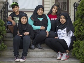 Mariam Hasno, centre, a Syrian refugee, is pictured with her children, clockwise from top left, Sobhi, 10, Aya, 12, Zainab, 14, and Riham, 13, at their home, Friday, June 2, 2017.