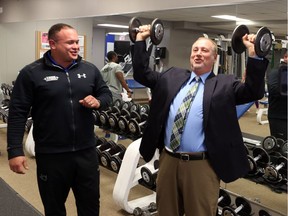 (file) Luis Mendez, Owner and Operator, True Fitness Windsor watches as Larry Horwitz, Chair of the DWBIA, lifts weights during a press conference on November 25, 2016.