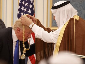 Saudi King Salman presents U.S. President Donald Trump with the highest civilian honor, the Collar of Abdulaziz Al Saud, at the Royal Court Palace, in Riyadh, Saudi Arabia on May 20, 2017.