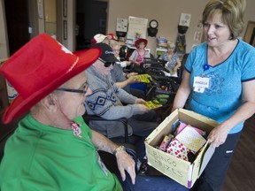 Angela Cross, a personal support worker with VON, hands out a bingo prize to Joe Mihalik, a client of the VON adult day program, Thursday, June 29, 2017.