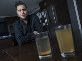 Former Ward 10 Coun. Al Maghnieh, a South Windsor resident, looks at two glasses of dirty drinking water from his tap on June 27, 2017.