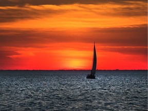 The sun sets over Lake St. Clair under extreme hot temperatures on June 12, 2017.