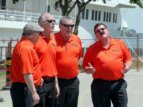 Barbershop quartet Intrigue, including its members Rob Grimmell, left, Rick Wilson, Dan Bezaire and Tom Grimes, perform as tourists from Pearl Mist, behind, and Victory I cruise ships came ashore on the Windsor waterfront on June 2, 2017.