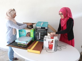 Volunteers Ghada Aljannati and Mahwish Ayub sort through donated items on May 31, 2017, for a new Muslim women's shelter in Windsor.