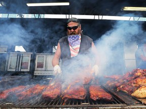 Tex Roberts Jr. from Louisiana cooks up a pile of ribs on Saturday, June 3, 2017 during the Windsor Ribfest at the Festival Plaza.