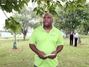 Windsor, Ontario. July 11, 2017. City Councillor John Elliott stands under a mature tree beside a newly-planted Arboretum at Ambassador Park on Riverside Drive West just north of Assumption Church.  Not only will the new trees supply a cooling canopy during the summer, but each tree has a plaque describing the native trees which grow along the banks of area rivers. TD Friends of the Environment Foundation provided funds for the project. Red Maple, Sugar Maple, Serviceberry, Blue Beech, Flowing Dogwood, Tuliptree, Burr Oak, Pin Oak and Red Oak were planted. (NICK BRANCACCIO/Windsor Star)
Nick Brancaccio, NIck Brancaccio